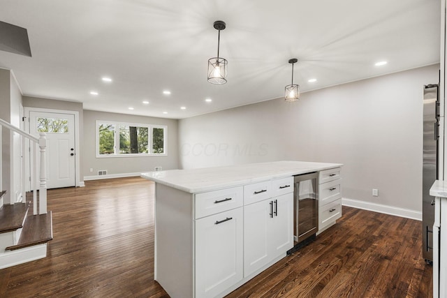 kitchen featuring beverage cooler, dark wood-style floors, baseboards, decorative light fixtures, and recessed lighting