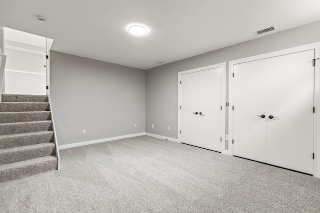 below grade area with stairway, carpet flooring, and baseboards