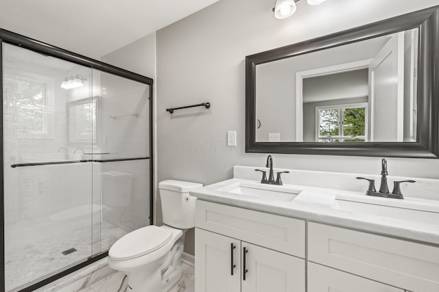 full bathroom featuring marble finish floors, toilet, double vanity, and a stall shower