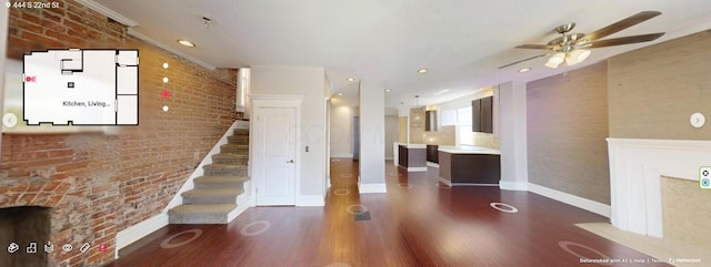 444 S 22nd St, Columbus, OH 43205 - unfurnished living room with a ceiling fan, wood finished floors, baseboards, stairway, and brick wall