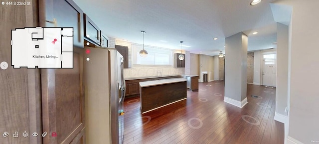 444 S 22nd St, Columbus, OH 43205 - kitchen featuring a kitchen island, dark wood-style flooring, light countertops, stainless steel fridge, and plenty of natural light