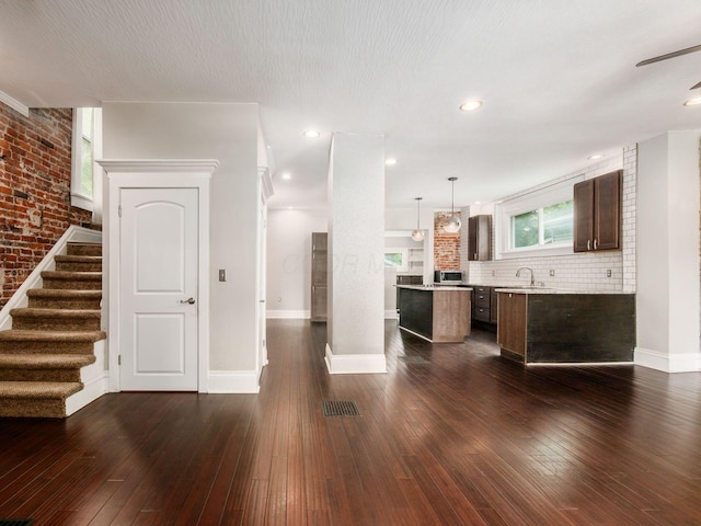 444 S 22nd St, Columbus, OH 43205 - kitchen with baseboards, dark brown cabinetry, a center island, dark wood-style floors, and recessed lighting