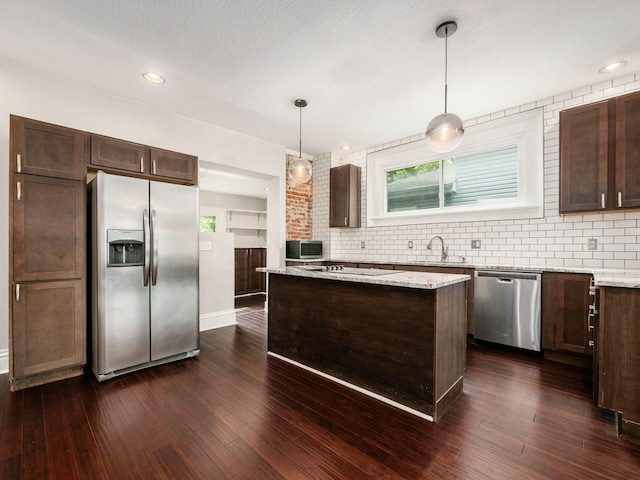 444 S 22nd St, Columbus, OH 43205 - kitchen featuring appliances with stainless steel finishes, dark brown cabinets, a center island, tasteful backsplash, and recessed lighting