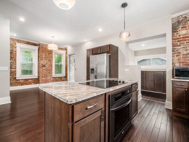 444 S 22nd St, Columbus, OH 43205 - kitchen featuring appliances with stainless steel finishes, dark wood finished floors, baseboards, brick wall, and light stone countertops