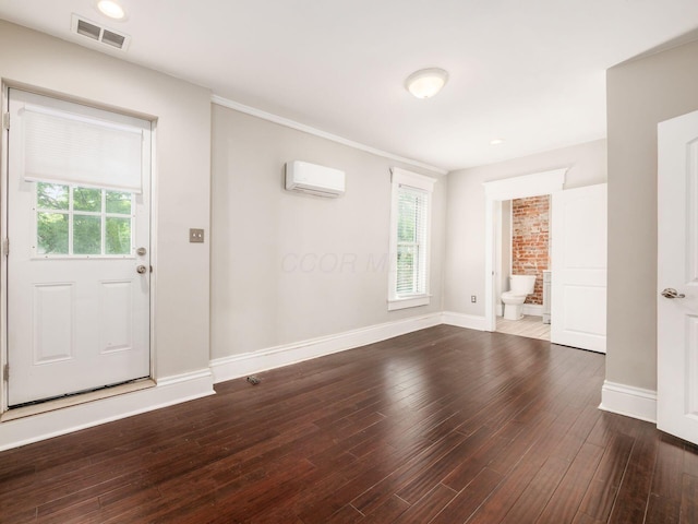 444 S 22nd St, Columbus, OH 43205 - foyer entrance featuring dark wood-style flooring, an AC wall unit, and baseboards