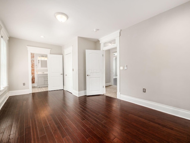 444 S 22nd St, Columbus, OH 43205 - unfurnished bedroom featuring baseboards, wood finished floors, and ensuite bath