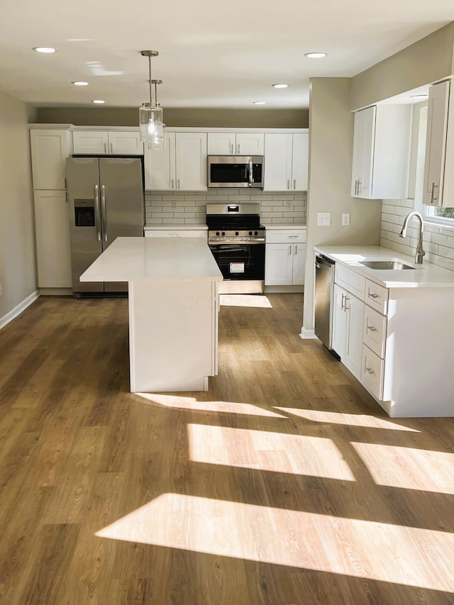 796 Village Park Dr, Powell, OH 43065 - kitchen with light countertops, white cabinetry, dark wood-type flooring, appliances with stainless steel finishes, and a sink