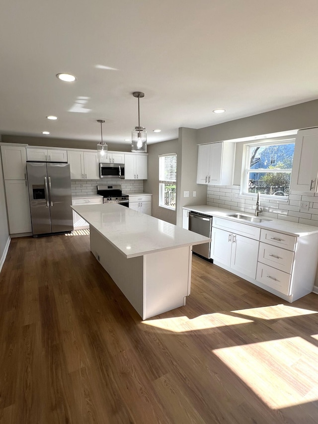 796 Village Park Dr, Powell, OH 43065 - kitchen featuring dark wood-style floors, a center island, white cabinetry, appliances with stainless steel finishes, and a sink
