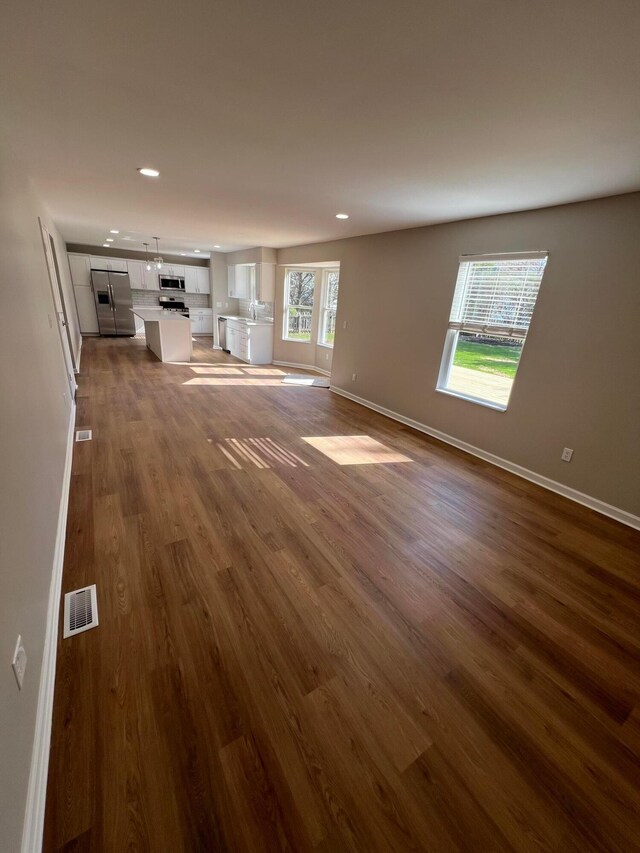 796 Village Park Dr, Powell, OH 43065 - unfurnished living room featuring recessed lighting, visible vents, baseboards, and dark wood finished floors