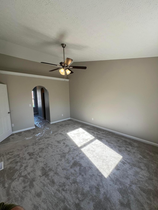 796 Village Park Dr, Powell, OH 43065 - carpeted empty room featuring arched walkways, a textured ceiling, a ceiling fan, lofted ceiling, and baseboards
