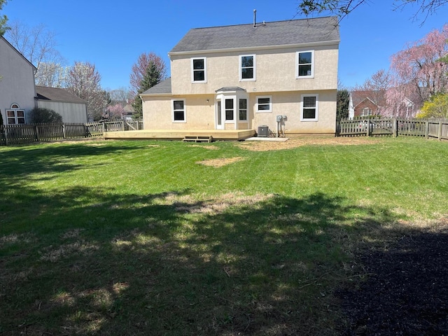 796 Village Park Dr, Powell, OH 43065 - back of property with stucco siding, central AC unit, a fenced backyard, a wooden deck, and a lawn