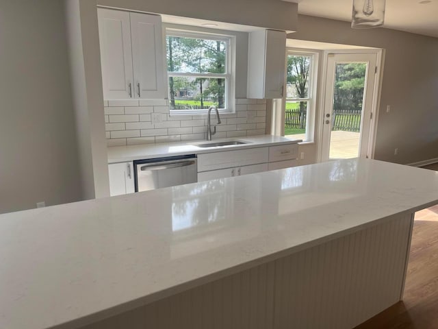 796 Village Park Dr, Powell, OH 43065 - kitchen with white cabinets, wood finished floors, dishwasher, a sink, and backsplash