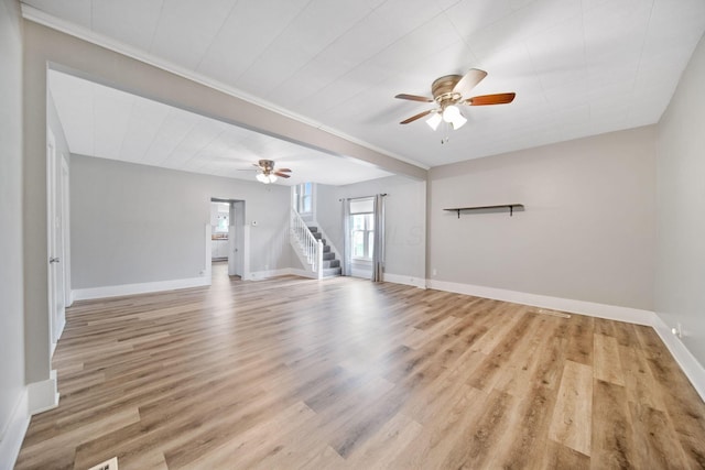 unfurnished living room featuring light wood-type flooring, stairway, baseboards, and a ceiling fan