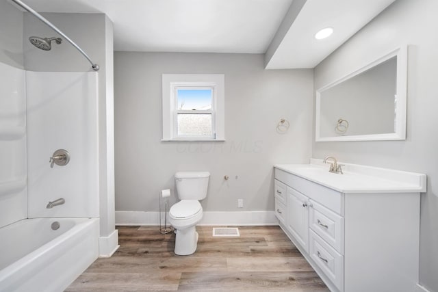 full bath with vanity, bathing tub / shower combination, toilet, visible vents, and wood finished floors