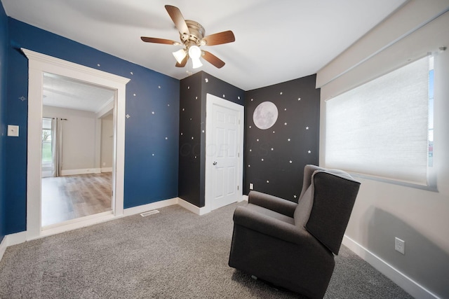 unfurnished room featuring carpet floors, baseboards, and a ceiling fan