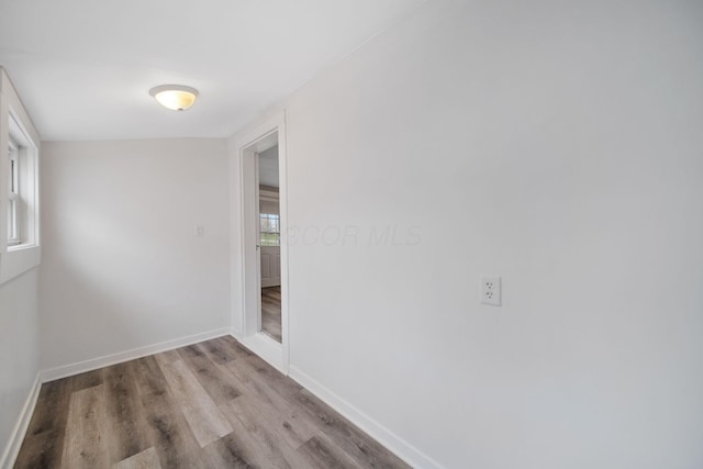 unfurnished room with wood finished floors and baseboards
