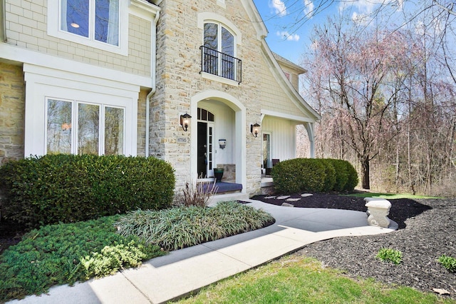 6795 Macneil Dr, Dublin, OH 43017 - property entrance featuring a balcony and stone siding