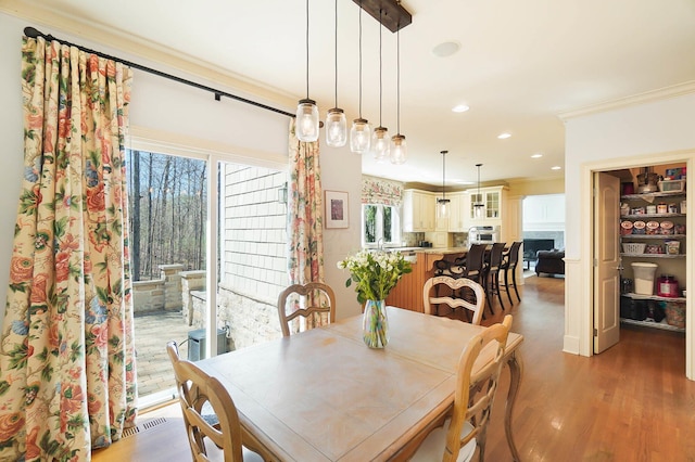 6795 Macneil Dr, Dublin, OH 43017 - dining space with light wood-style floors, ornamental molding, and recessed lighting