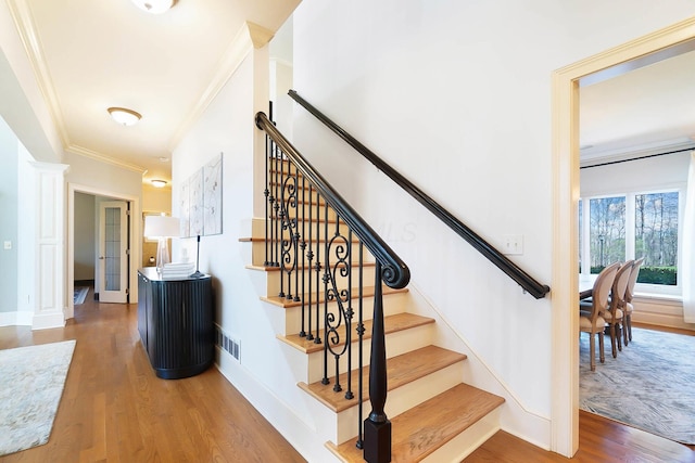 6795 Macneil Dr, Dublin, OH 43017 - stairs with crown molding, wood finished floors, baseboards, and visible vents