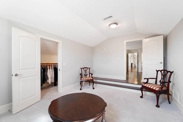6795 Macneil Dr, Dublin, OH 43017 - sitting room with light carpet, visible vents, baseboards, and vaulted ceiling