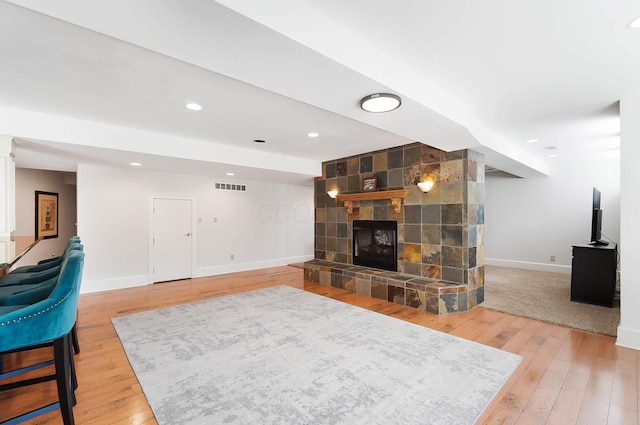 6795 Macneil Dr, Dublin, OH 43017 - living room featuring a large fireplace, visible vents, baseboards, and wood-type flooring