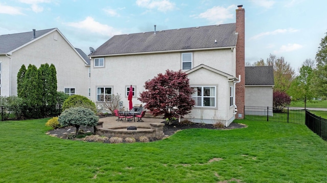 back of property with a chimney, a lawn, a fenced backyard, a patio, and stucco siding