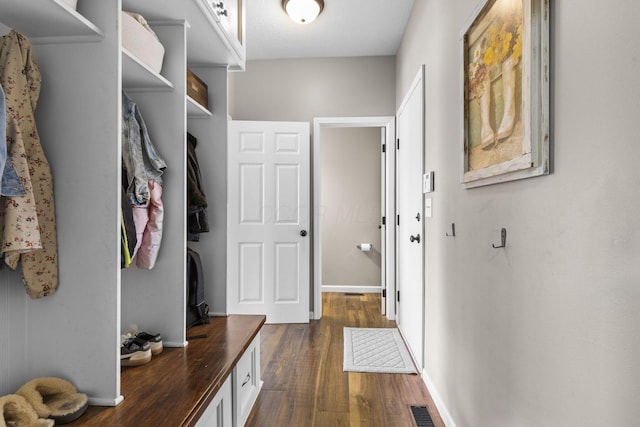 mudroom with visible vents, dark wood finished floors, and baseboards