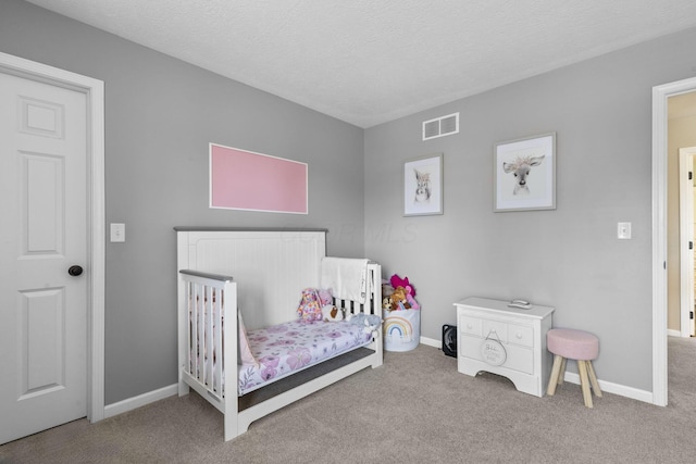 bedroom with carpet floors, baseboards, and visible vents