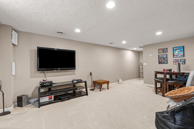 living area featuring a textured ceiling, visible vents, baseboards, carpet, and recessed lighting