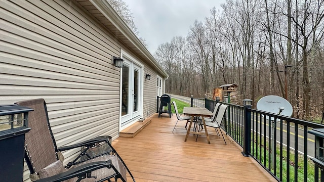 deck with french doors and a grill