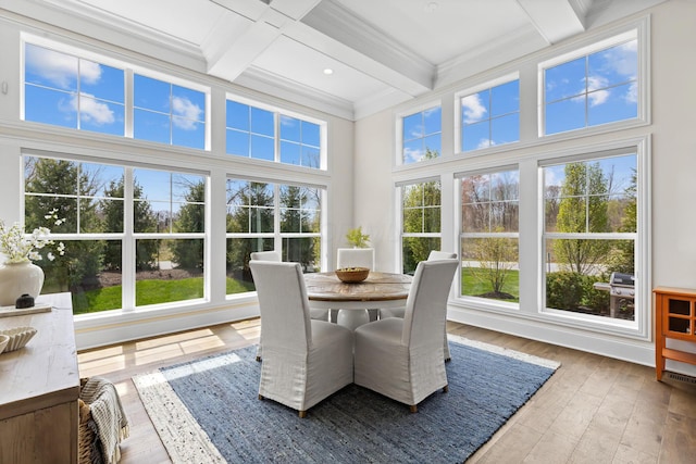 sunroom with plenty of natural light, beam ceiling, and coffered ceiling