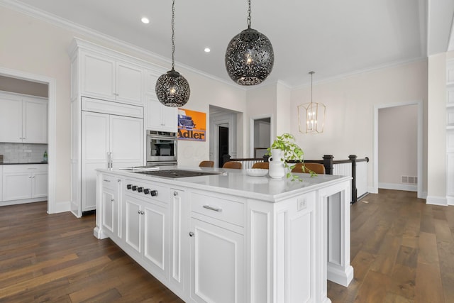 kitchen with white cabinets, an inviting chandelier, visible vents, decorative backsplash, and stainless steel oven