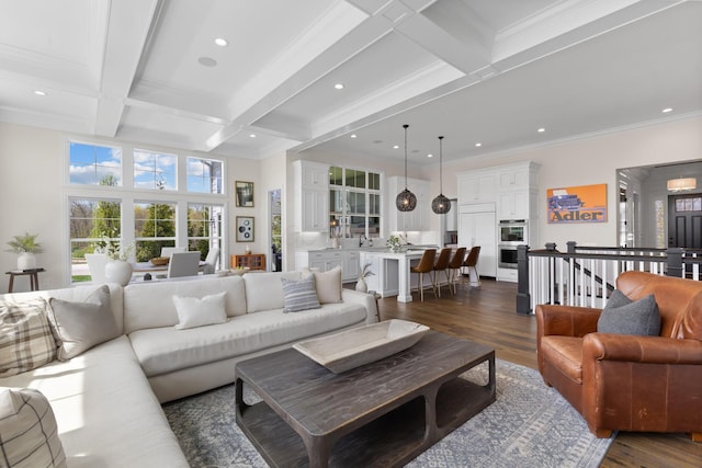 living area featuring beamed ceiling, coffered ceiling, and dark wood finished floors