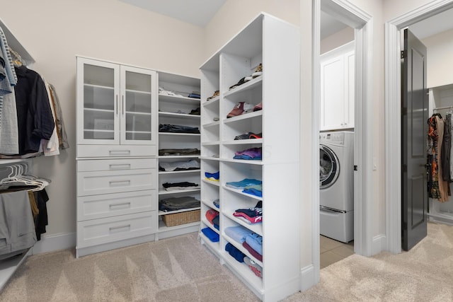 walk in closet featuring light carpet and washer / clothes dryer