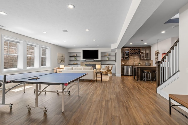 playroom with dark wood-type flooring, wet bar, and recessed lighting