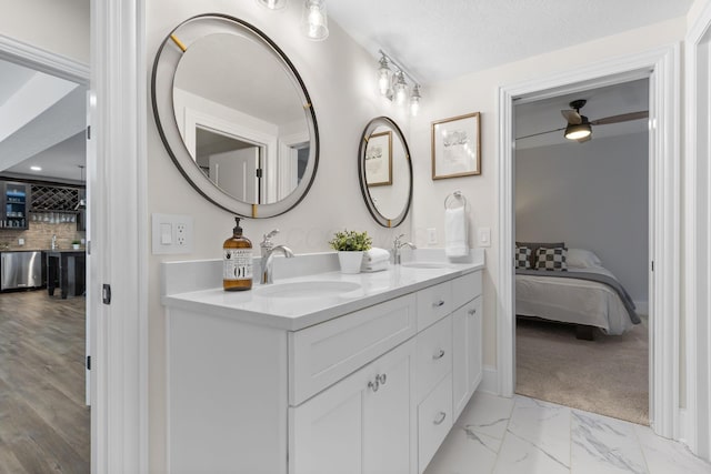 full bathroom with decorative backsplash, a sink, double vanity, and connected bathroom