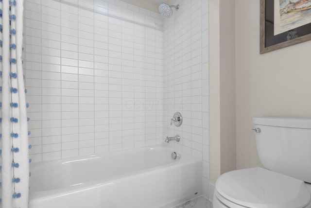 bathroom with marble finish floor, shower / bath combo with shower curtain, toilet, and baseboards