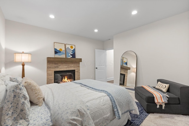 bedroom featuring a fireplace and recessed lighting