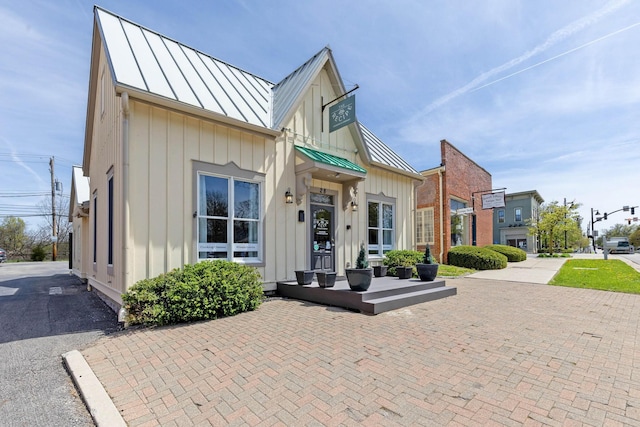 view of front of property featuring a standing seam roof, board and batten siding, and metal roof