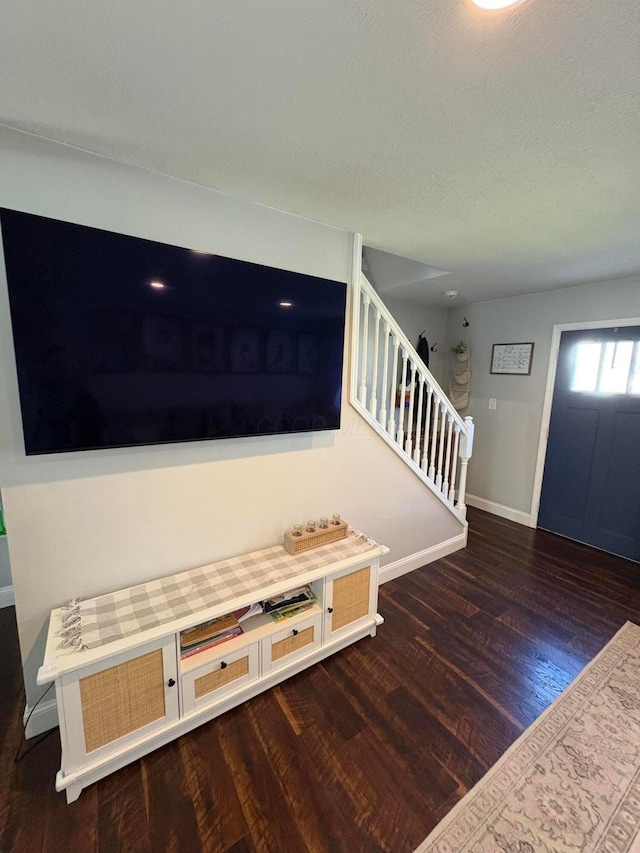 foyer with baseboards, stairway, and wood finished floors