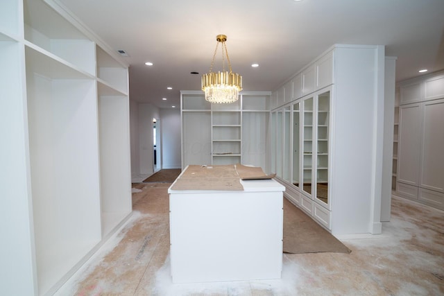 spacious closet with visible vents and an inviting chandelier