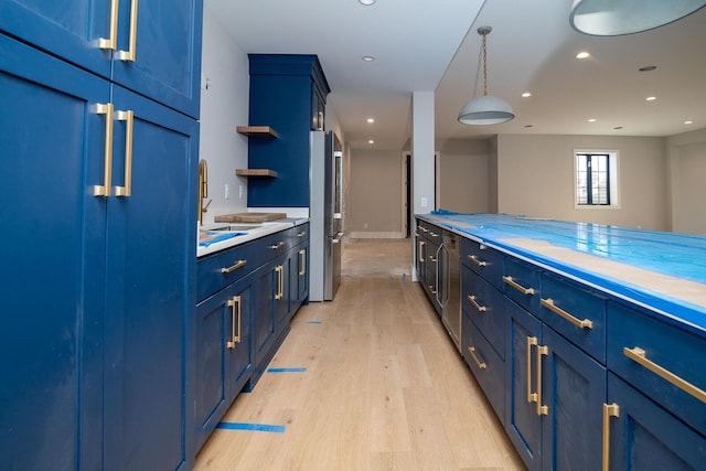 kitchen with open shelves, light countertops, freestanding refrigerator, light wood-style floors, and blue cabinets