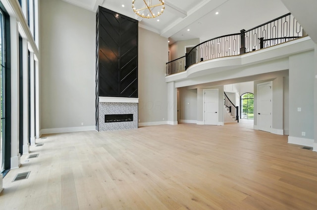 10007 Allen Dr, Dublin, OH 43017 - unfurnished living room featuring wood finished floors, stairway, baseboards, beamed ceiling, and a high ceiling