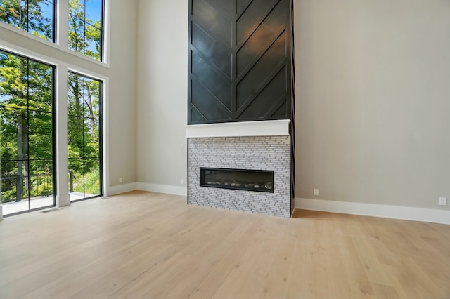 10007 Allen Dr, Dublin, OH 43017 - unfurnished living room with wood finished floors, baseboards, and plenty of natural light