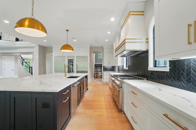 10007 Allen Dr, Dublin, OH 43017 - kitchen featuring a sink, arched walkways, stainless steel appliances, white cabinets, and custom exhaust hood