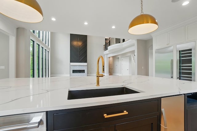 10007 Allen Dr, Dublin, OH 43017 - kitchen featuring a sink, open floor plan, recessed lighting, hanging light fixtures, and light stone counters