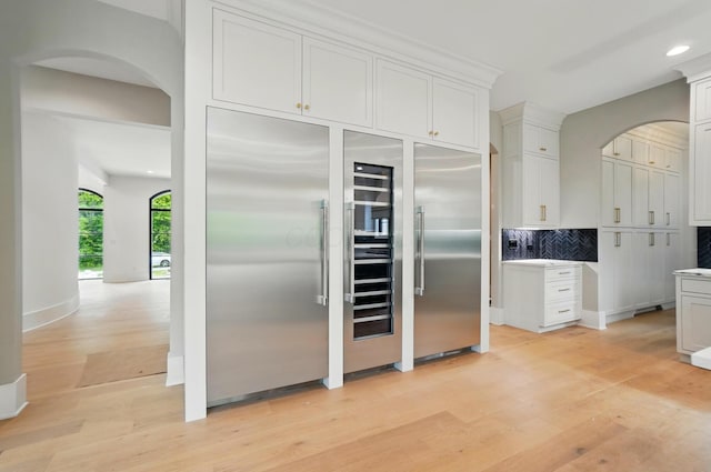 10007 Allen Dr, Dublin, OH 43017 - kitchen with arched walkways, light wood-style floors, high quality fridge, and recessed lighting