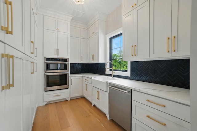 10007 Allen Dr, Dublin, OH 43017 - kitchen with appliances with stainless steel finishes, a sink, light wood-style floors, and white cabinetry