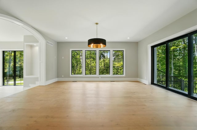 10007 Allen Dr, Dublin, OH 43017 - empty room with baseboards, light wood-type flooring, recessed lighting, and arched walkways
