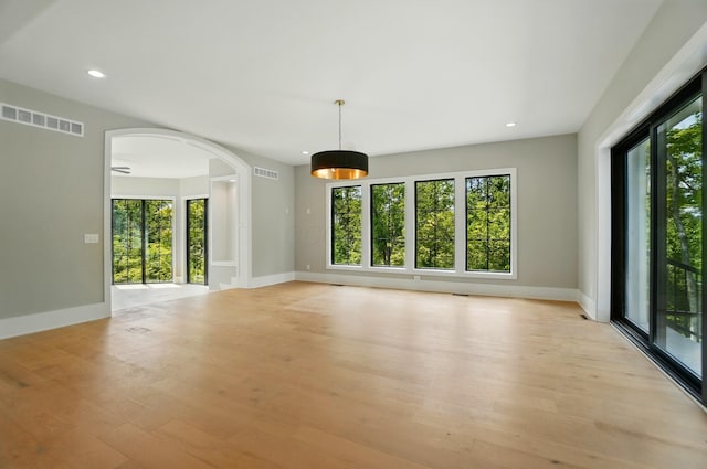 10007 Allen Dr, Dublin, OH 43017 - spare room featuring healthy amount of natural light, arched walkways, light wood-type flooring, baseboards, and recessed lighting